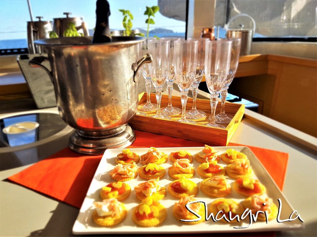 Delicious Sunset Snack and drinks on crewed catamaran charter Shangri La 